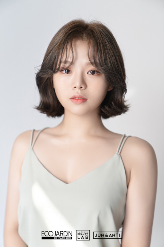 단발머리에 CS컬 펌으로 적당히 포인트를 주고 매트브라운 컬러의 베이스에 포인트 부분 탈색을 더해 시크한 느낌을 준 후 사이드 뱅으로 얼굴선을 감싼 헤어스타일
